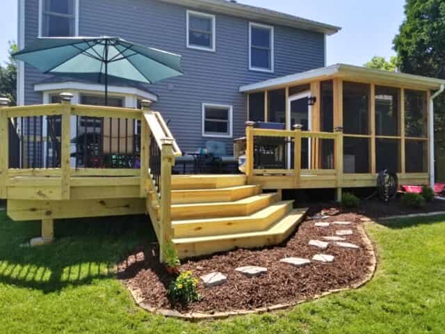 Wood deck with wide staircase and attached screened porch